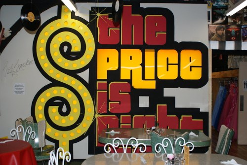 Colorful mural featuring the phrase "the Price is Right" with a dollar sign design in a retro diner setting.