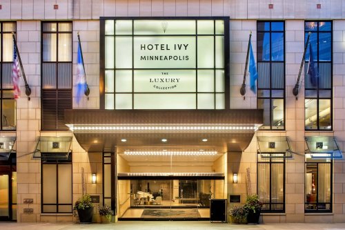 Exterior view of Hotel Ivy in Minneapolis, featuring a modern entrance and illuminated signage.