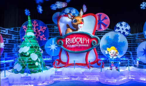 Colorful ice sculptures featuring Rudolph the Red-Nosed Reindeer, a Christmas tree, and a cheerful character in a winter scene.