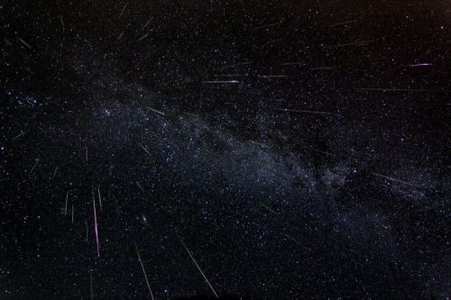 A stunning night sky filled with stars and meteor trails, showcasing the Milky Way galaxy.