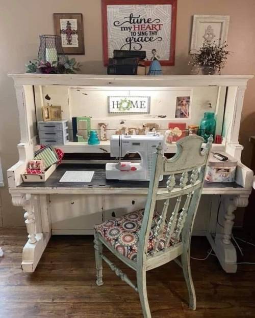 A vintage sewing desk with a sewing machine, colorful decor, and a chair, set in a cozy, well-decorated room.