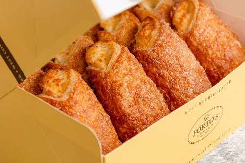 A box of golden, flaky pastries with a crispy exterior, neatly arranged and ready to be enjoyed.