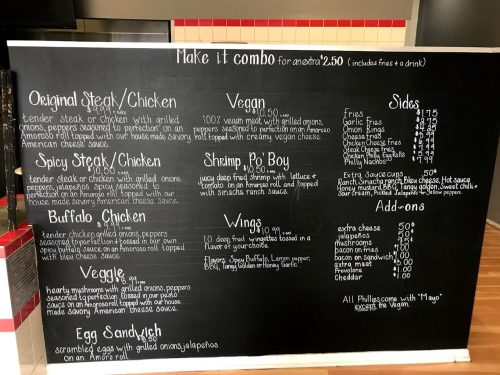 Menu board featuring various meal options, including steak, chicken, shrimp, and sides, with prices listed.