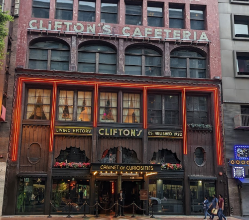 Historic Clifton's Cafeteria building with vibrant signage and decorative windows, showcasing a unique architectural style.