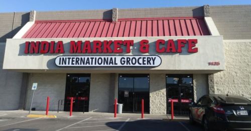 Exterior of India Market & Cafe, an international grocery store, featuring a red roof and large signage.