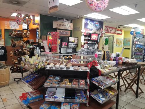 A colorful convenience store display featuring snacks, baked goods, and drinks, with a cozy, inviting atmosphere.