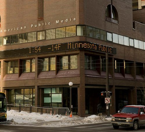 Exterior of the American Public Media building with a digital display showing the time and temperature in Minnesota.