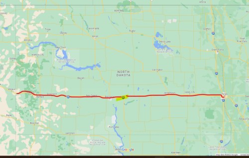 Map of North Dakota highlighting a highway route with towns and geographical features marked.