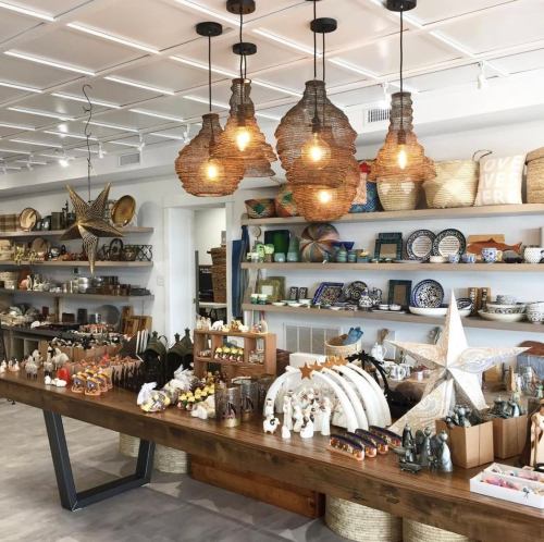 A cozy shop interior featuring decorative items, handmade crafts, and unique lighting fixtures.