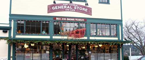 Exterior of the Port Gamble General Store and Café, decorated for the holidays with lights and greenery.