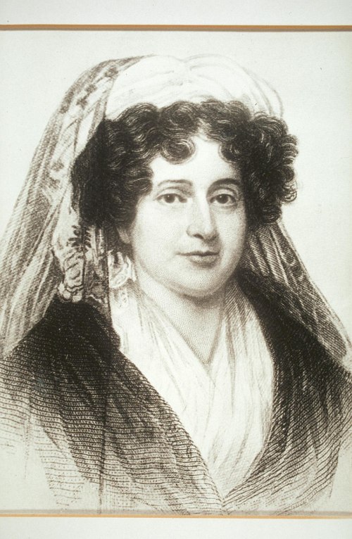 A historical portrait of a woman with curly hair, wearing a headscarf and a dark dress, looking directly at the viewer.