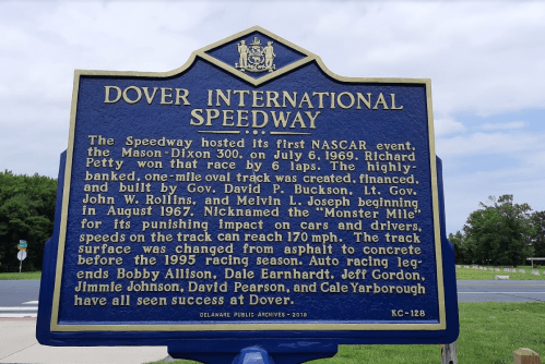 Historical marker for Dover International Speedway, detailing its first NASCAR event and notable racing facts.