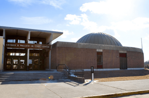 Exterior view of the George C. Wallace Jr. Civic Center, featuring a modern building and a domed structure.