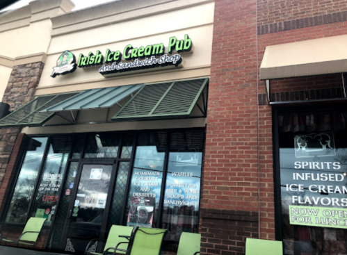 Exterior of the Irish Ice Cream Pub, featuring a sign and windows displaying ice cream and sandwich offerings.