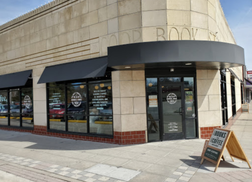 Exterior of a bookstore and coffee shop with large windows and a sign promoting books and coffee.