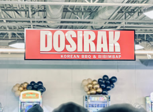 Sign for "Dosirak" featuring Korean BBQ and Bibimbap, with decorative balloons in the background.