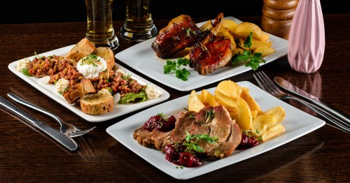 Dinner table with different dishes set on the table.