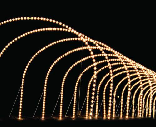 A series of glowing lights arranged in arches against a dark background, creating a festive atmosphere.