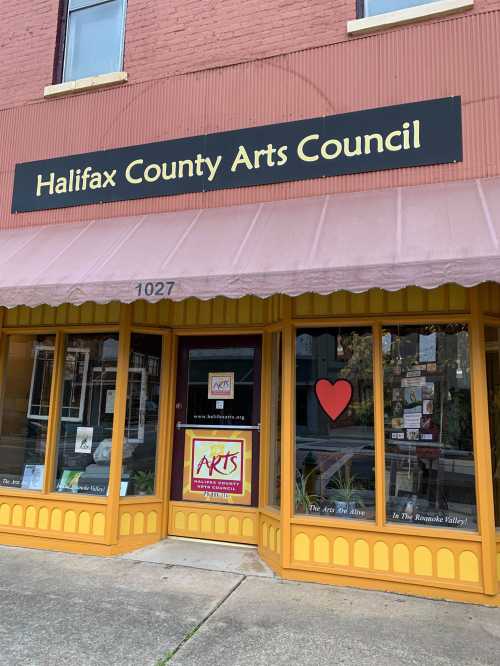 Front of the Halifax County Arts Council building, featuring a heart decoration and colorful signage.