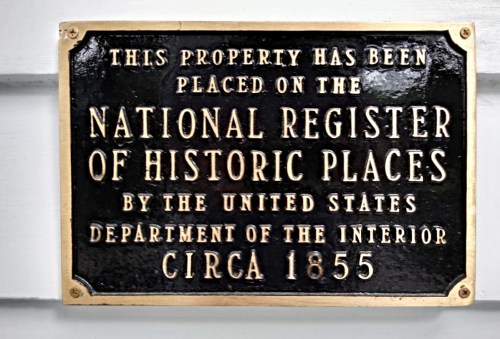 A bronze plaque stating the property is on the National Register of Historic Places, dated circa 1855.
