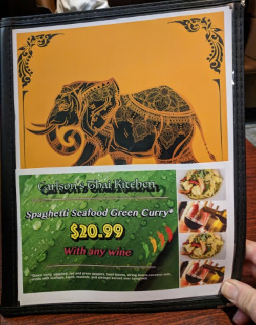 Menu page featuring an elephant design and a dish of Spaghetti Seafood Green Curry priced at $20.99.
