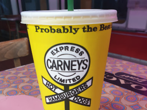 A yellow cup with a logo for Carney's, featuring the text "Probably the Best" and "Hot Hamburgers, Hot Dogs."