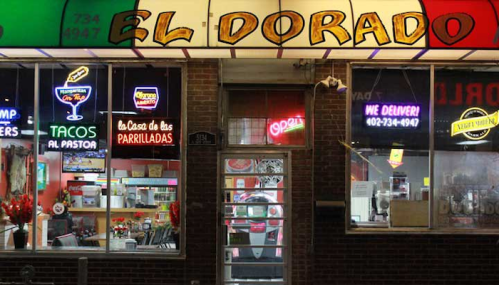 Brightly lit restaurant exterior with "El Dorado" sign, featuring neon lights and a welcoming "Open" sign.