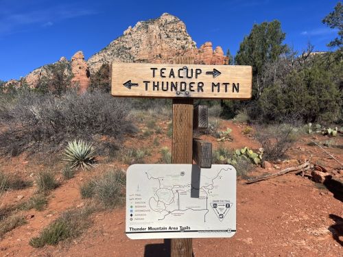 A wooden signpost points to Teacup and Thunder Mountain, with a map of the Thunder Mountain area below.