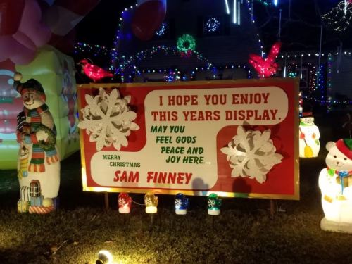 A festive sign reads, "I hope you enjoy this year's display. Merry Christmas, Sam Finney," surrounded by holiday decorations.