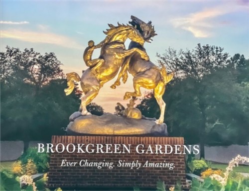 A golden horse statue rears up at Brookgreen Gardens, with a sunset backdrop and lush greenery. Text: "Ever Changing. Simply Amazing."