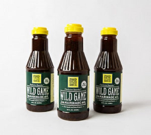 Three bottles of Wild Game Marinade with yellow caps and green labels, arranged in a row.
