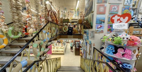A colorful store interior with decorative items, plush toys, and a staircase leading to different sections.