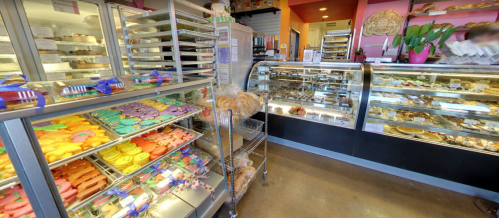 A colorful display of cookies and pastries in a bakery, with glass cases showcasing various treats.