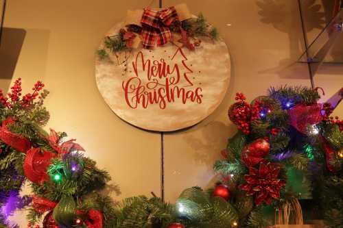 A festive decoration featuring a "Merry Christmas" sign surrounded by colorful garlands and ornaments.