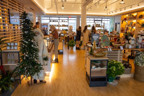 A cozy store interior filled with various home goods, decorations, and shoppers browsing among the displays.