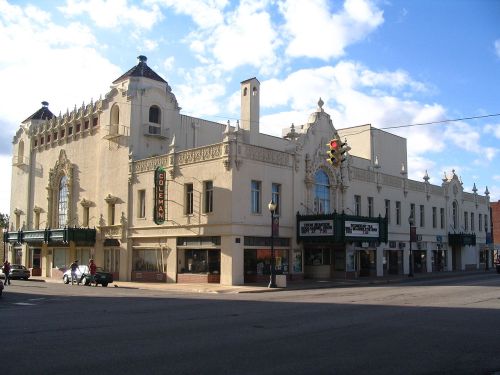 Historic building with ornate architecture, featuring a marquee and decorative details, located at a street corner.