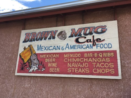 Sign for Brown Mug Cafe featuring Mexican and American food, listing menu items like beer, chimichangas, and Navajo tacos.