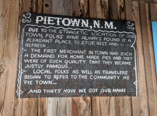 Signboard explaining the origin of the name "Pietown, N.M." and its history of pie-making and community significance.