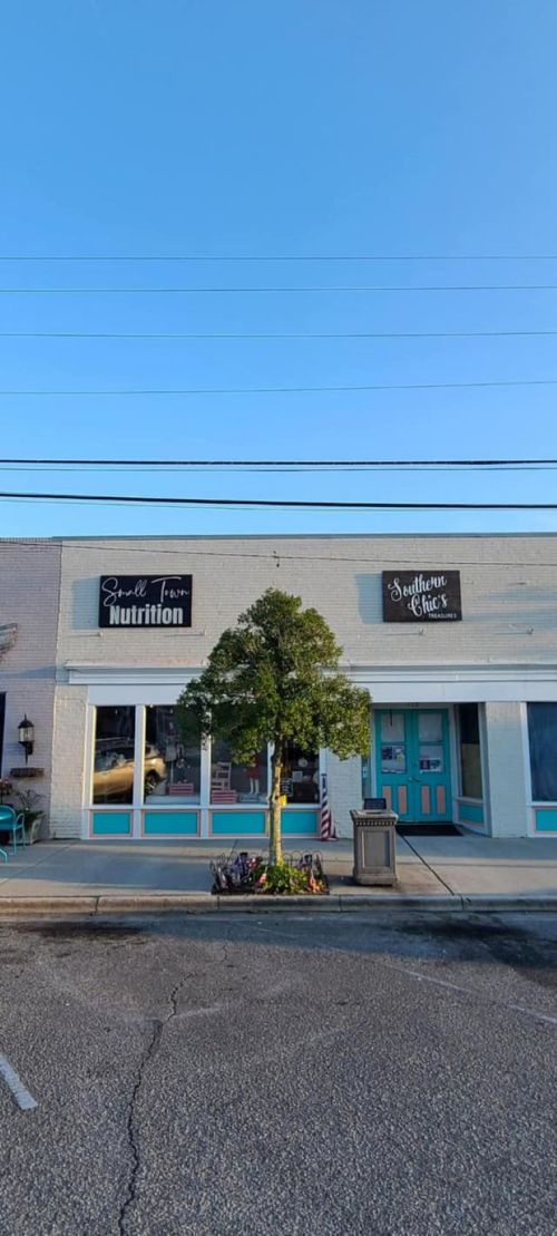 A storefront with two signs: "Soul From Nutrition" and "Southern Chefs," featuring a small tree in front.