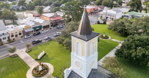 aerial with St. Martinville, Louisiana with a focus on a church spire