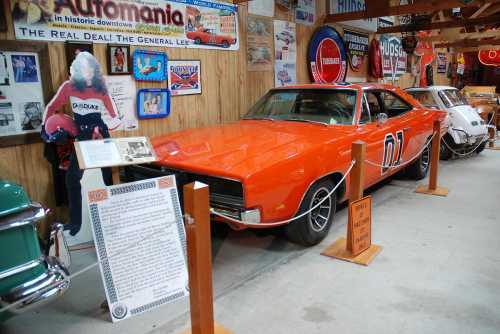 An orange car with the number 01 parked in a museum, surrounded by vintage signs and memorabilia.