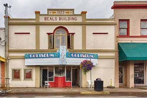 Historic Beals Building featuring the Coliseum marquee, with colorful signage and a charming facade.