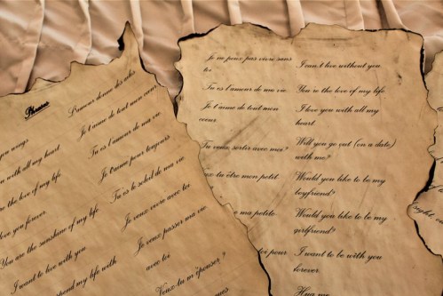Two aged parchment sheets with handwritten love letters, expressing deep emotions and romantic proposals.