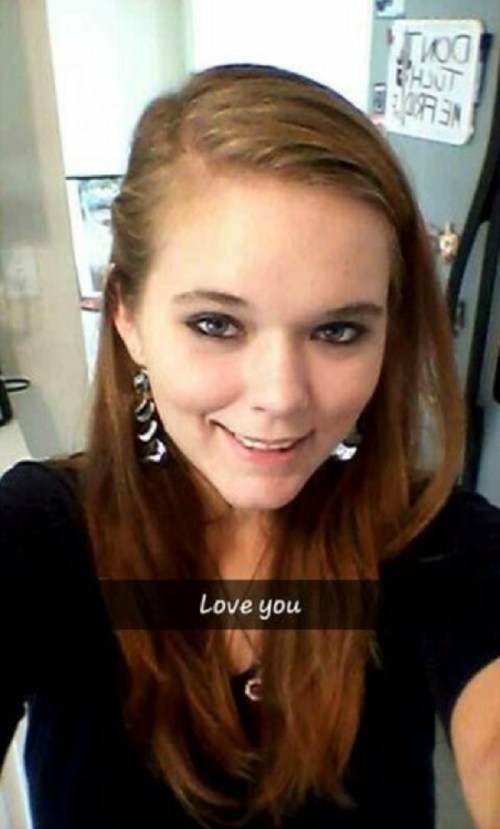 A young woman with long brown hair smiles at the camera, wearing earrings and a black top, with a text overlay saying "Love you."