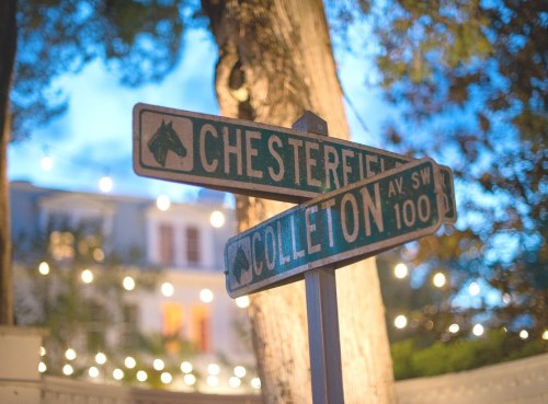 Street signs for Chesterfield and Colleton Avenue, illuminated by soft lights in the background.
