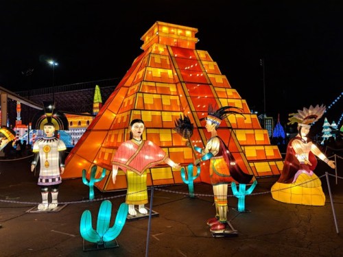 Colorful lanterns depicting a pyramid and figures in traditional attire, set against a night sky.