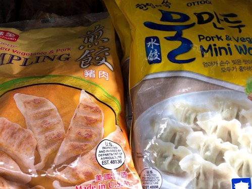 Two packages of frozen dumplings: one labeled "Pork & Vegetable Dumpling" and the other "Pork & Veg Mini Wontons."