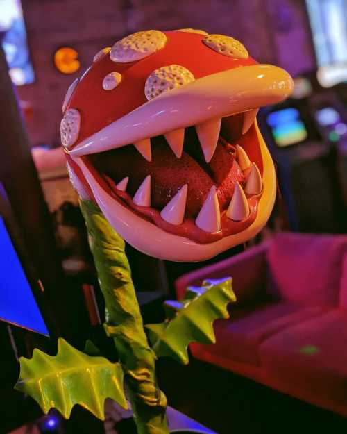 A colorful, oversized plant with a large, open mouth and sharp teeth, resembling a piranha plant from video games.