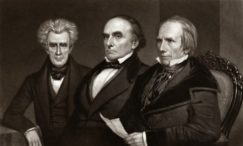 A historical portrait of three men in formal attire, seated together, with a dark background.