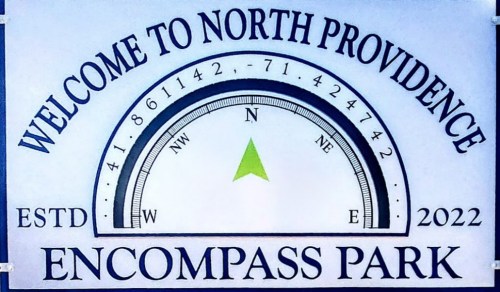 Sign welcoming visitors to Encompass Park in North Providence, featuring a compass design and established date of 2022.